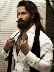 Photo of very sexy muscular man with handlebar mustache, beard and long hair.